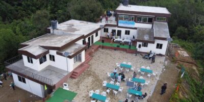 Bird view of Serchhip Paragliding site made from LGSF steel on a hill top where outsude table and chairs are set to sit for guests